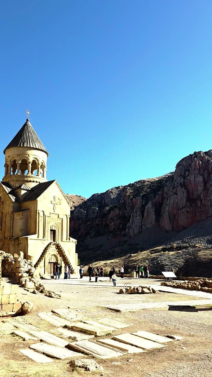The Noravank monastery church beneath red sandstone cliffs