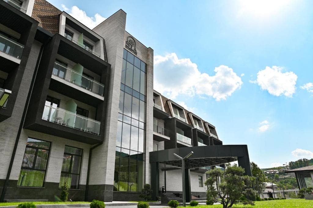 The contemporary glass-and-stone facade of the resort