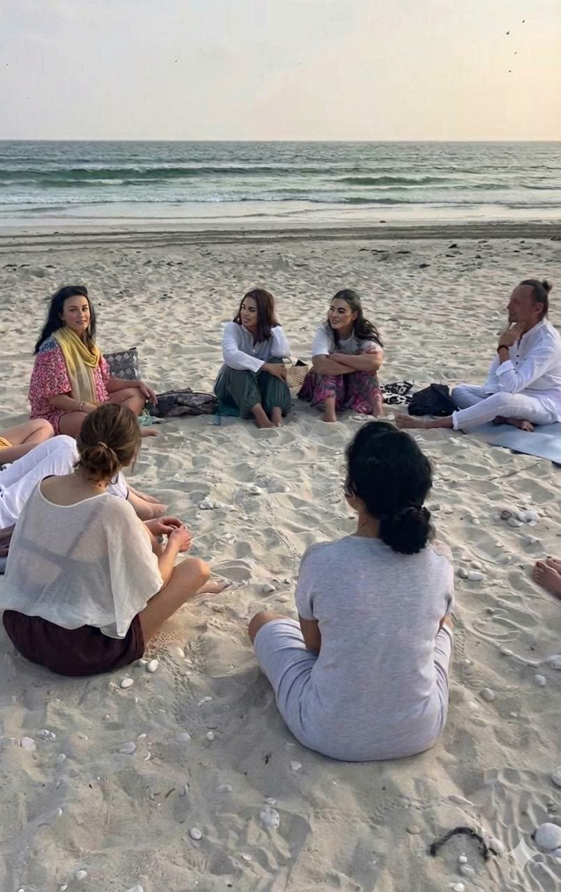 A sharing circle on the beach at dusk