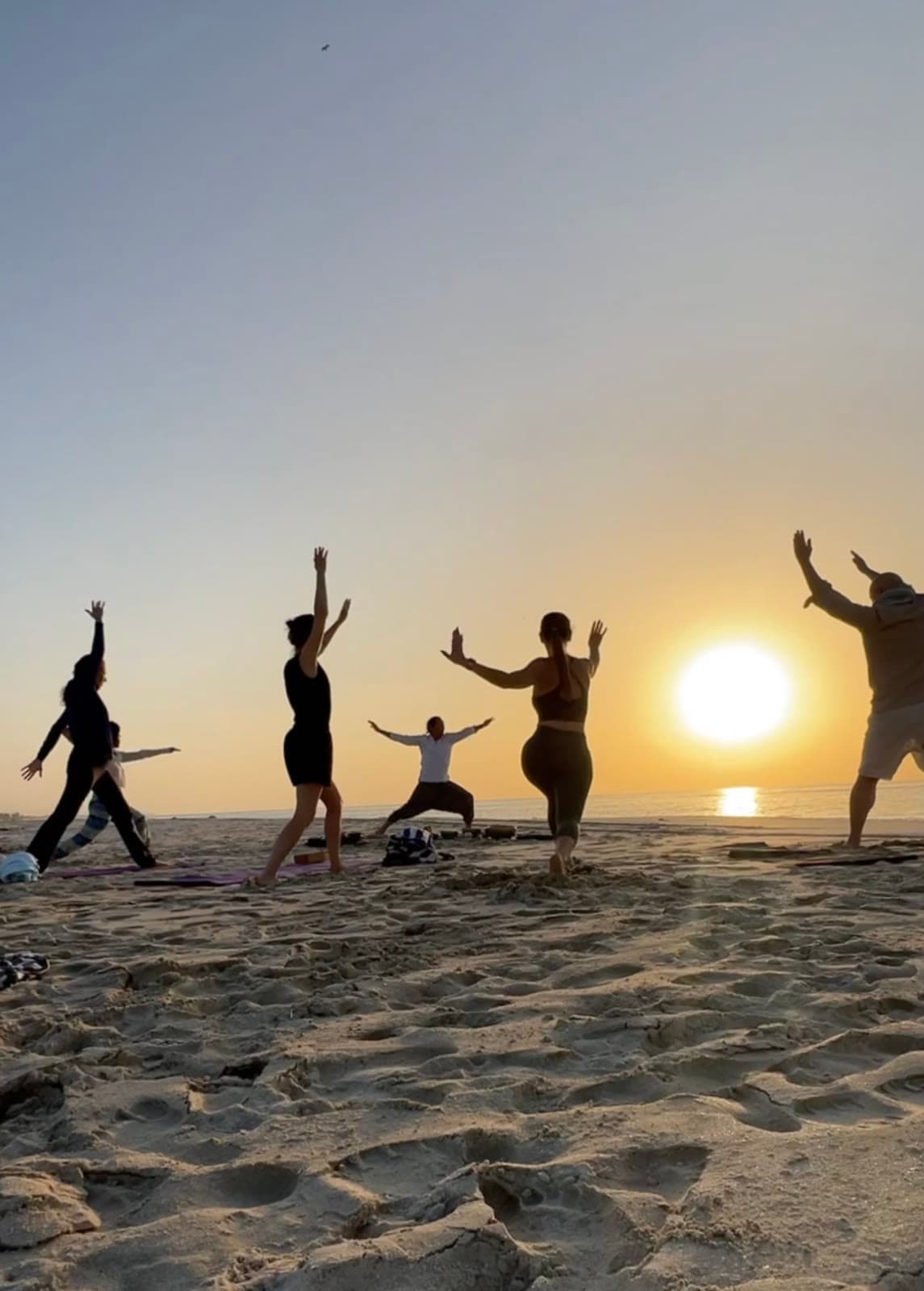 Group sunrise practice on the beach