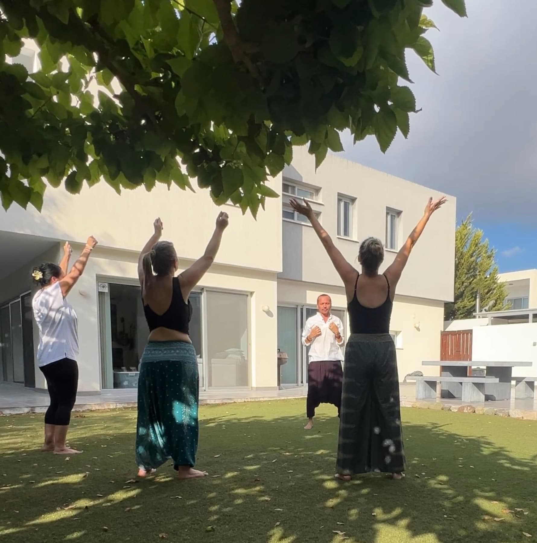 An outdoor group practice in a garden