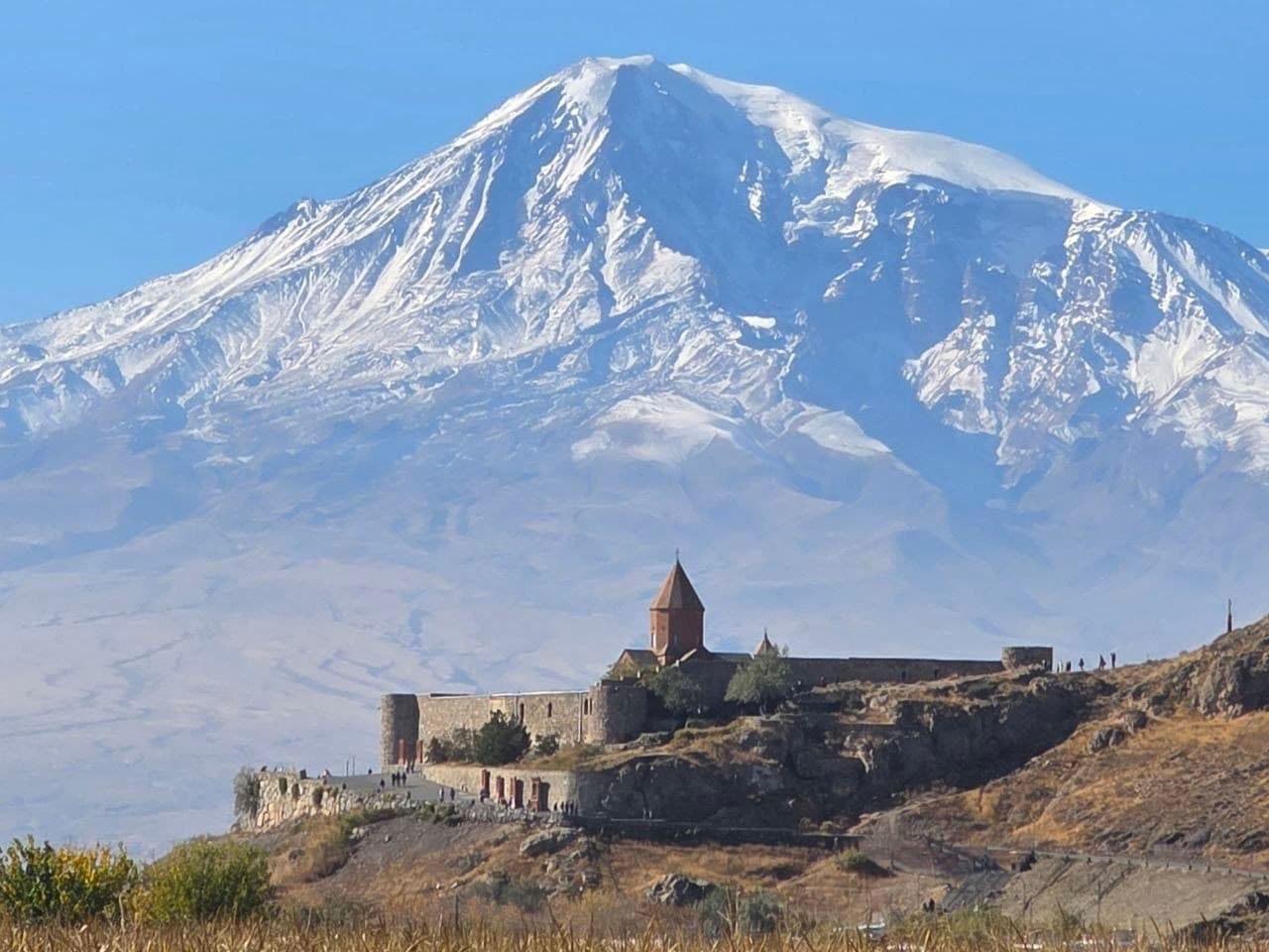 Khor Virap monastery on its hill below the snow-covered twin peaks of Mount Ararat, Armenia