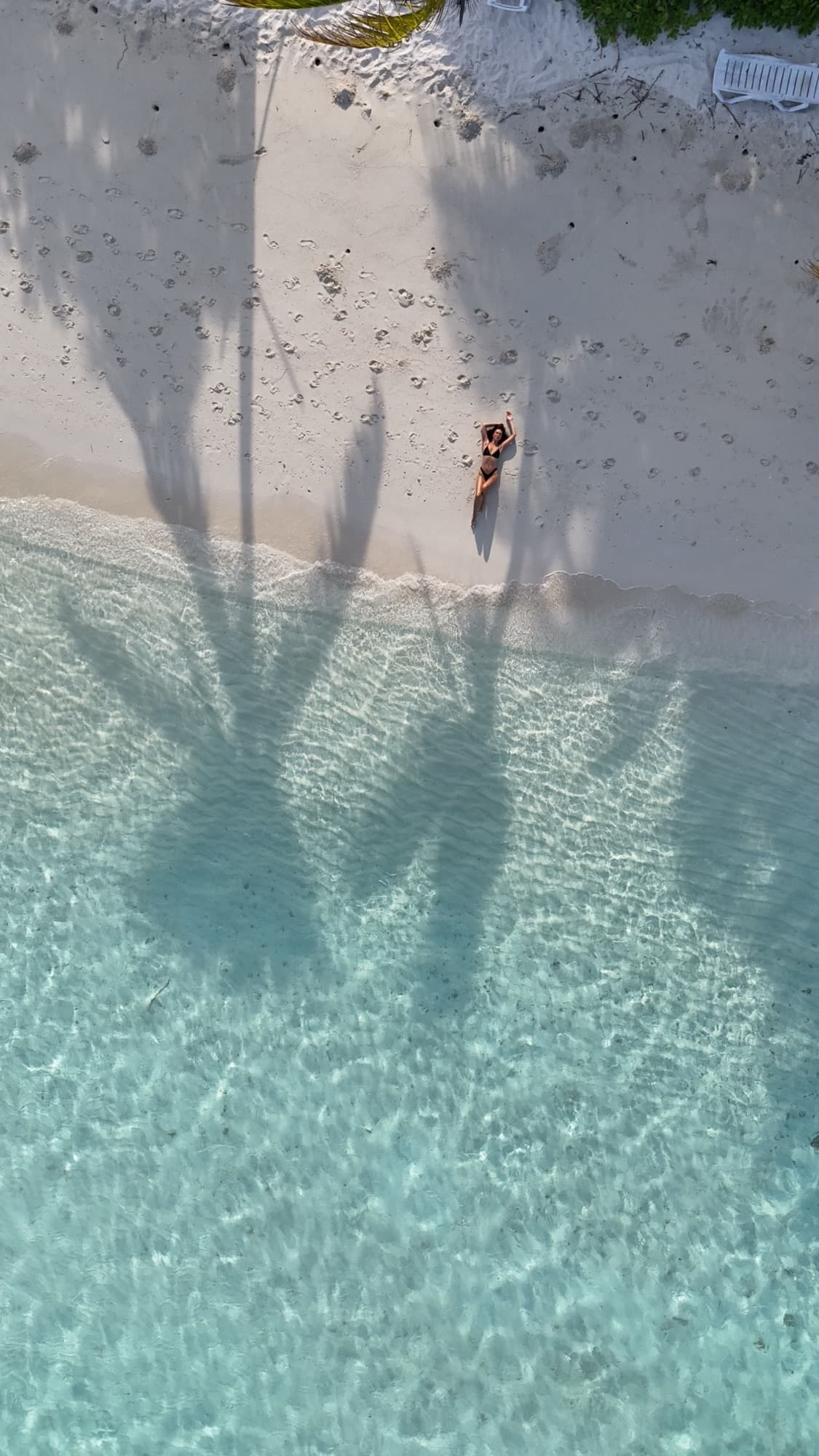 A turquoise lagoon and pale sand from above